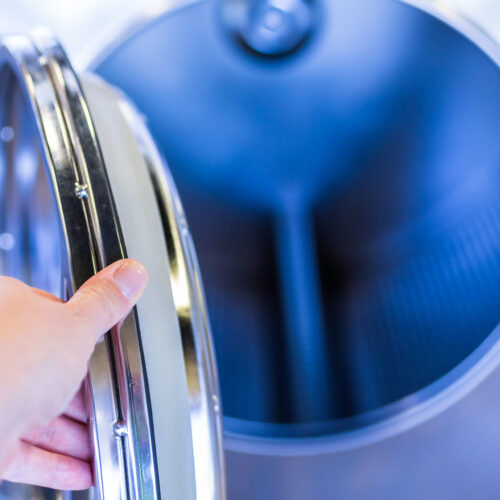 Industrial washing machines in a public laundromat.